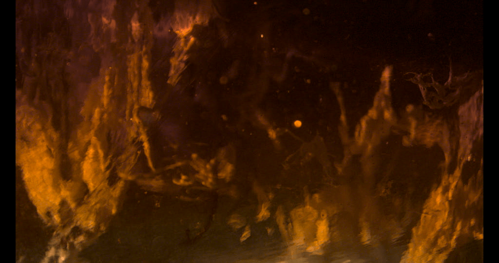 Frame grab paint suspended in viscous fluid.